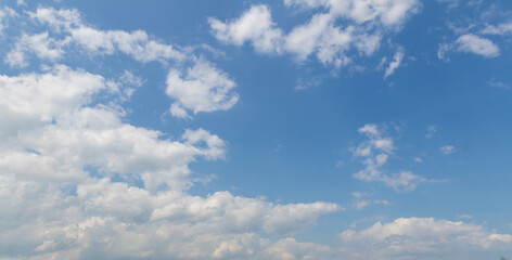 sky replacement horizontal panoramic looking up at blue sky with white puffy clouds in summer