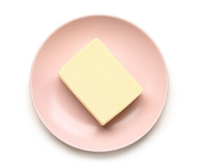 Plate with fresh butter on white background