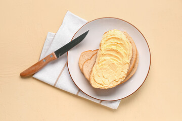 Plate of tasty toast with butter on yellow background