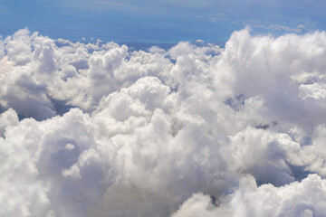 Naklejka na ściany i meble Aerial view of clouds and coastline in the background.