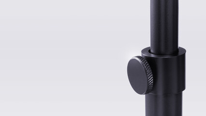 Closeup of floor lamp pole height adjustment mechanism on light grey copyspace background.