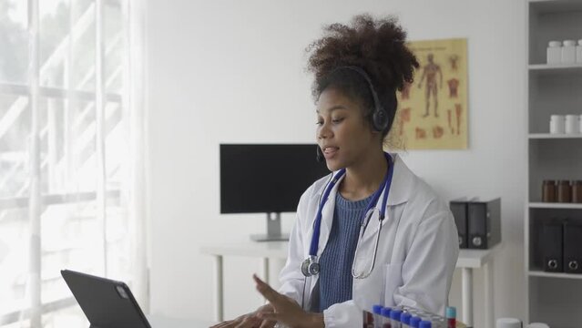 African female doctor wearing stethoscope calling patient online video consultation Female therapist video conferencing talking to camera in remote chat concept of health awareness