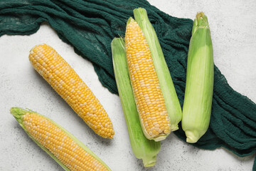 Fresh corn cobs on light background