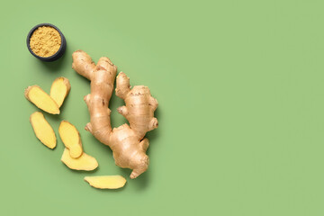 Fresh ginger root and bowl of dried powder on green background