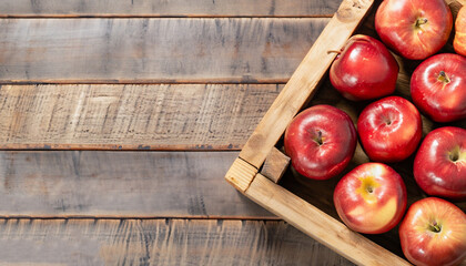 Ripe red apples in wooden box top view on rustic table. Wide apple banner with space for your text