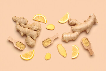 Fresh ginger roots, slices of lemon and wooden scoops with dried powder on orange background