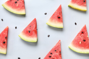 Composition with pieces of ripe watermelon on light background