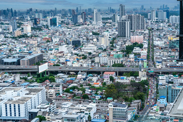 Condominium buildings, houses, expressway roads in the middle of the city. High angle view of the capital city of Bangkok, 