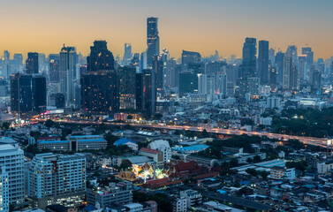 Fototapeta na wymiar Condominium buildings, houses, expressway roads in the middle of the city. High angle view of the capital city of Bangkok, 