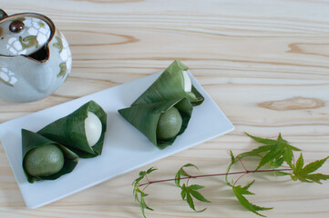 Sasa dango is a dark green with a flavor of mugwort dessert with a filling of sweet red bean paste and finally a good wrap of bamboo leaves.