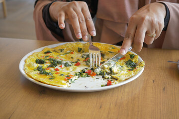 eating Plain Egg Omelette on table 