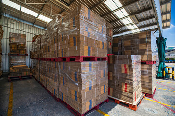Folded cardboard boxes in the warehouse. Stack of flat industrial folding cardboard packing