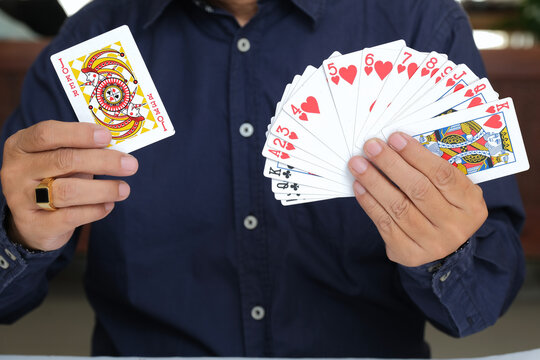 Close-up shot of magician's hands playing card magic tricks