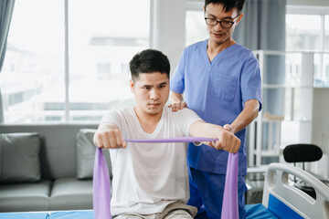 Physiotherapist Helping Patient While Stretching His Leg in bed