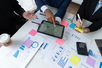 business professional Confident group of young business people analyzing, strategy, planning, brainstorming, calculating, finding information, presenting ideas using laptops and notepads in key areas