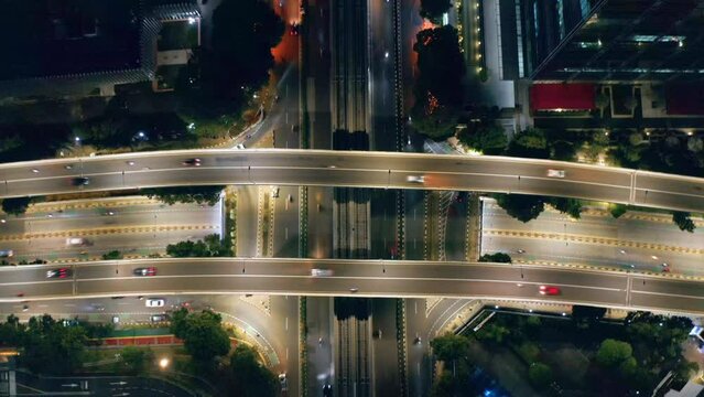 Top-down aerial view of huge intersection with overpass road at night - Jakarta, Indonesia