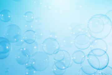 Fototapeta na wymiar Beautiful Transparent Blue Soap Bubbles Floating in The Air. Abstract Blurred Background. Celebration Festive Backdrop. Refreshing of Soap Suds, Bubbles Water. 