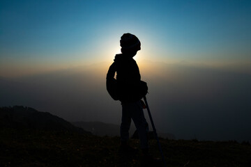 silhouette of a person on a mountain top