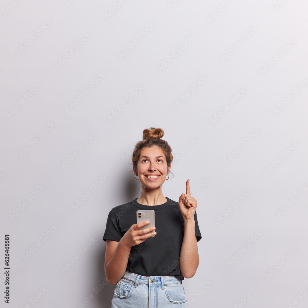 Poster indoor waistup of fit pretty cheerful european female wearing casual clothes standing in centre isol