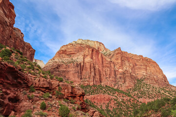 Fototapeta premium Scenic view of Navajo Sandstone mountain peak Mount Carmel in Zion National Park in Washington County, Utah, United States, USA. Southwest aspect centered, viewed from Springdale. Uninhabited canyon