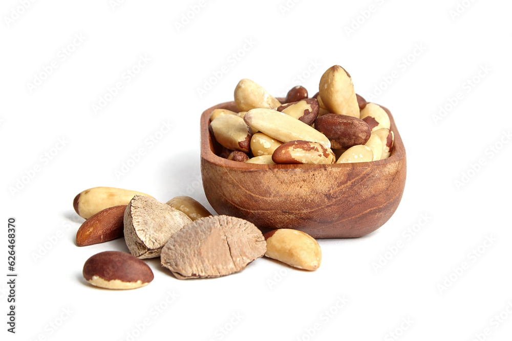 Wall mural brazil nuts in wooden bowl isolated on white. peeled brazil nuts.