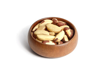 Brazil nuts in wooden bowl isolated on white. Peeled brazil nuts.