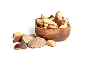 Brazil nuts in wooden bowl isolated on white. Peeled brazil nuts.