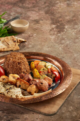 Mix grill main course on a rustic wooden surface - closeup