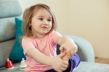 Funny portrait of cute Asian little girl playing at home. Close up, copy space.