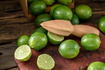 Zesty Citrus Delight: Close-Up of Lemon and Lime Fruit with a Wooden Hand Tool Squeezer, Capturing the Freshness in 4K Resolution