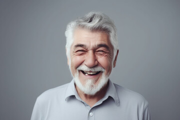 Happy old man on grey background
