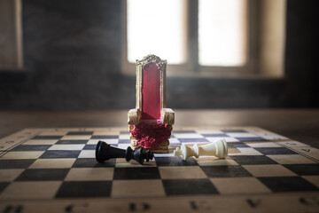 Red royal chair miniature on wooden table. Medieval Throne on chessboard. Chess board game concept...