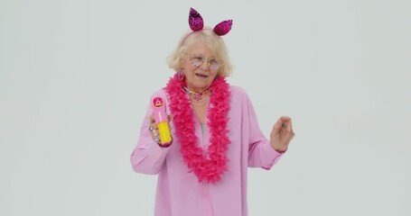 beautiful glamourous woman in fashionable clothes, funny glasses, beads, earrings headband dancing while making babbles, never give up Happiness, old granny is full of energy isolated white background