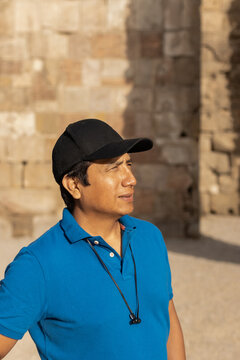 Latin man in the street wearing a cap during his vacations in Barcelona (Spain).