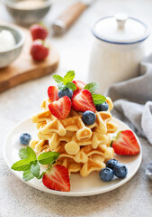 Freshly baked waffles with strawberries and blueberries