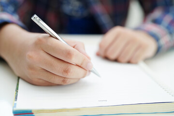 Asian teenage student write homework, study lesson for exam online learning education.