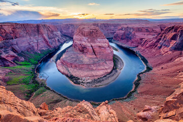 Horseshoe Bend, a meander of the Colorado River in the Glen Canyon area of Arizona, at sunset. - Powered by Adobe