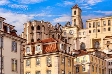 Obraz premium Historic buildings in central Lisbon, Portugal, with the Carmo Convent ruins, destroyed by an earthquake in 1755.