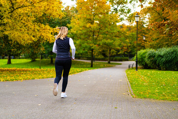 Healthy lifestyle - woman running in city park
