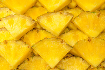 Pineapple juicy yellow slices as a background.