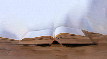 an old book leaning on some old pages