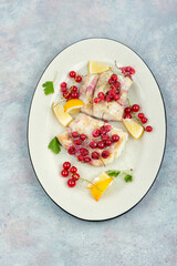 fried cod fillet with berries.