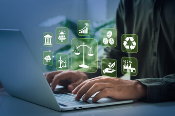 Businessman typing computer with environmental law icons on virtual screen. concept. global environmental law and global industry.