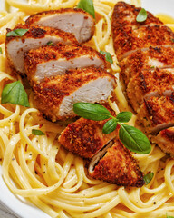 crusted chicken over lemon butter pasta, top view