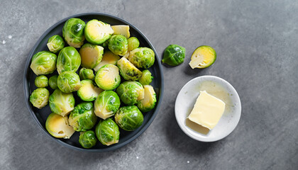 Brussels sprouts roasted with butter on gray slate background. Vegan Food Concept. Copy space, top view, flat lay