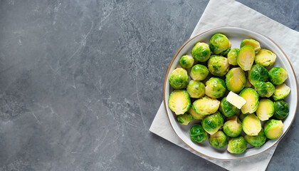 Brussels sprouts roasted with butter on gray slate background. Vegan Food Concept. Copy space, top...