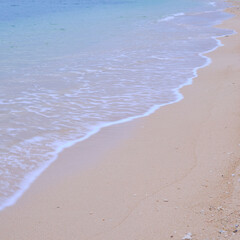 Calm sandy beach and pier in the morning