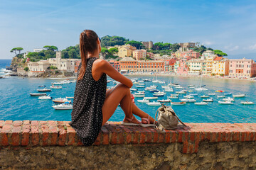 Tourist woman in Sestri Levante, Liguria, Italy. Summer beach, sea