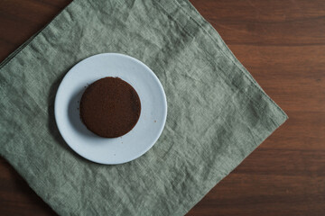 Used coffee puck on a saucer