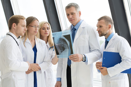 Group of doctors looking at x-ray